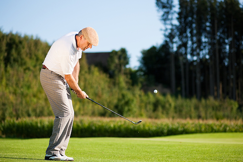 older man playing golf